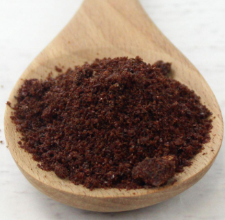 Ground Sumac Spice on a wooden spoon