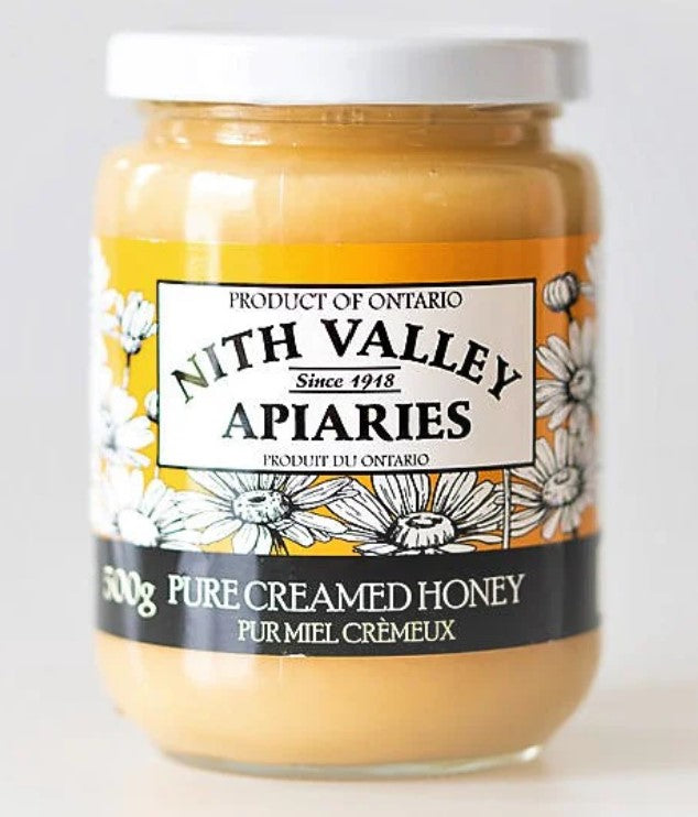 Jar of Nith Valley Apiaries pure creamed honey on a white background