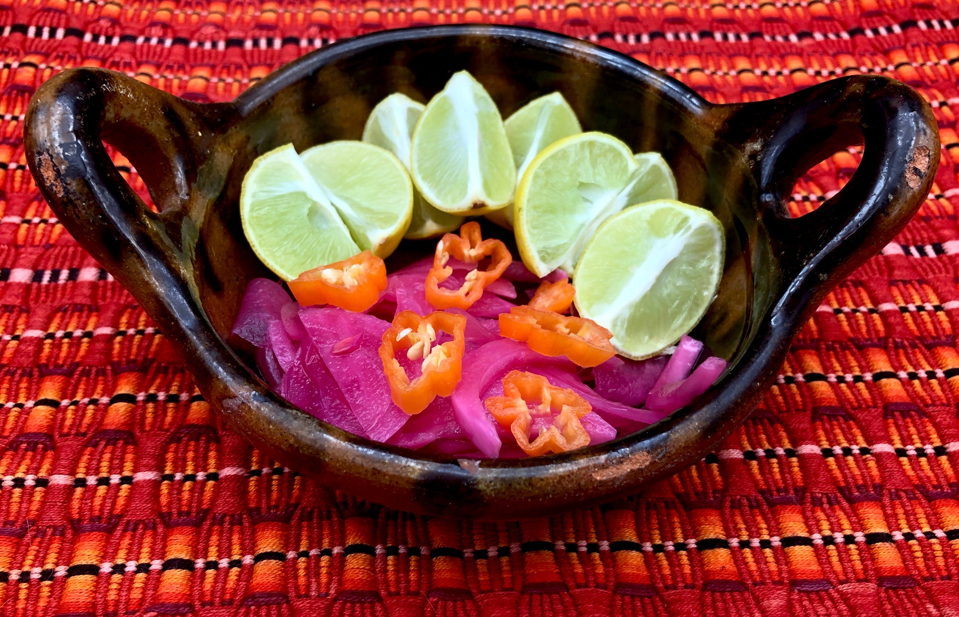 sliced habanero peppers and key limes in a dish. Our key