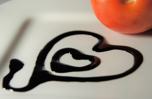 A heart drawn on a plate with balsamic vinegar
