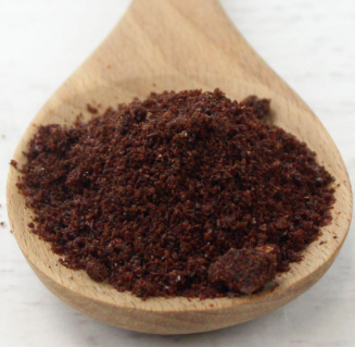 Ground Sumac Spice on a wooden spoon 